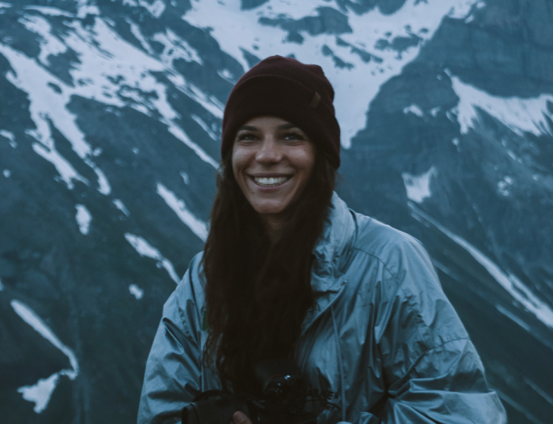 Theresa in the snow with mountains in the background