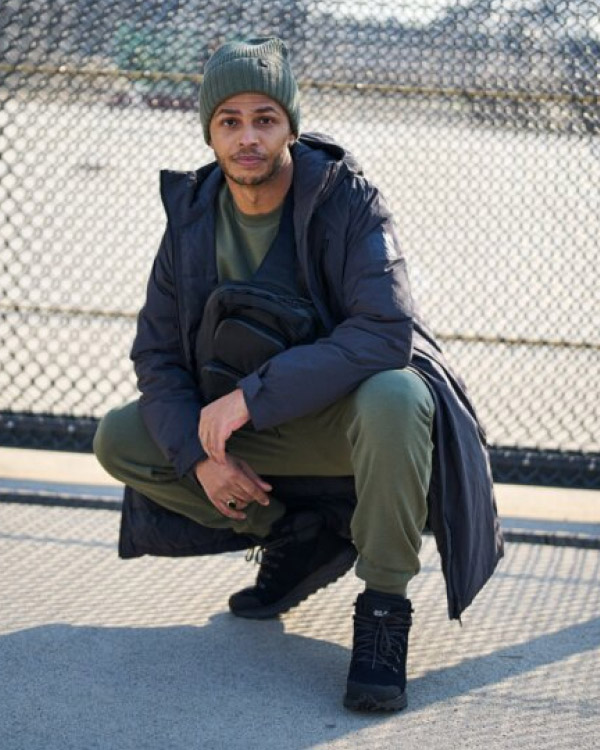 Man squatting and looking at the camera